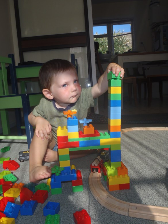 Building a tower is serious business. Mama helped get the bridge structure going (since Daddy wasn't home yet), and I embellished it with flowers and a tall asymmetrical tower.