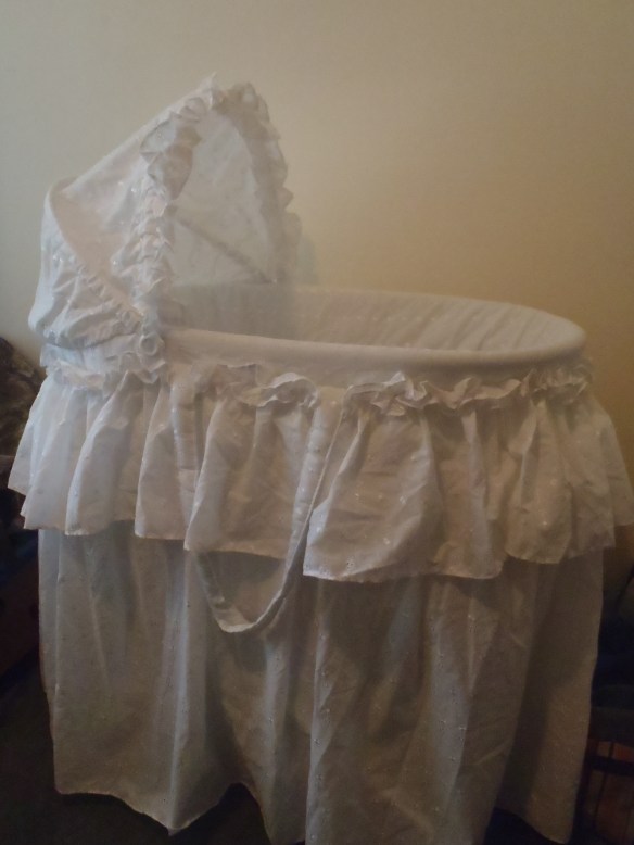 Chatting to some Playcenter moms (or Playcentre Mums, as they say here), someone asked about accommodations for the new baby. I had been thinking along the lines of a blanket-lined clothes basket to start out, but that must have seemed a bit roughish to them because one of the other moms generously offered the loan of their bassinet. I graciously accepted, having in my mind's eye the plain woven basket my parents had as a bassinet for us. The clinking and clanking inside the hefty bag was the first hint that this bassinet was not to be such a simple affair. I pulled it out one evening to have a look and two college-educated adults spent the next 1.5 hours puzzling over its assembly, with Milo's enthusiastic "help." Not that there are lots of pieces either.....  After 3 or 4 restarts we finally got it looking like a photo we found on the internet.